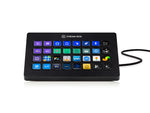 Load image into Gallery viewer, Front view of the Elgato Stream Deck XL showing 32 customizable LCD keys lit up with various icons, resting on its black magnetic stand.
