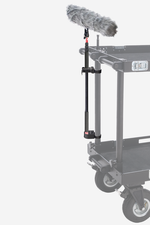 Load image into Gallery viewer, Mule Cart Boom Holder securely mounted to a vertical cart tube, holding a black boom pole. The holder features a Quick Fist clamp and a base cup with an XLR slot.