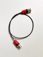 Load image into Gallery viewer, DIT Tools 12G SDI Thin HighFlex cable with right-angle and straight BNC connectors, coiled to demonstrate its extreme flexibility.
