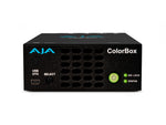 Load image into Gallery viewer, AJA ColorBox in-line color transformer, showing its compact black chassis with front panel LEDs and rear panel showing 12G-SDI and HDMI ports.
