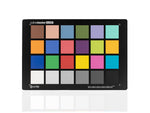 Load image into Gallery viewer, The Calibrite ColorChecker Classic Mega, a large color calibration chart with 24 colored squares, held up in an outdoor landscape setting.