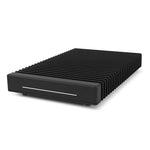Load image into Gallery viewer, OWC ThunderBlade Gen 2, a sleek black external solid-state drive, shown on a professional's desk next to a laptop.