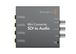 Load image into Gallery viewer, Blackmagic Design Mini Converter - SDI to Audio, a compact metal unit showing SDI input, loop out, and four 1/4-inch audio output jacks.
